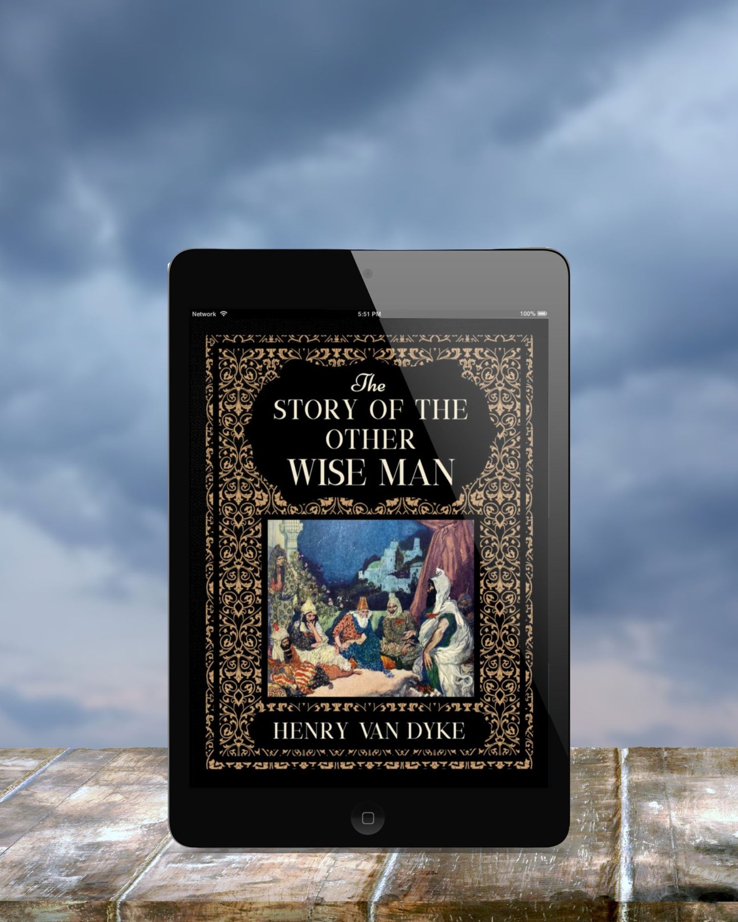 Black tablet standing upright on a brick wall in front of grey clouds. The ebook on display is the ornate black and gold cover of "The Story of the Other Wise Man."
