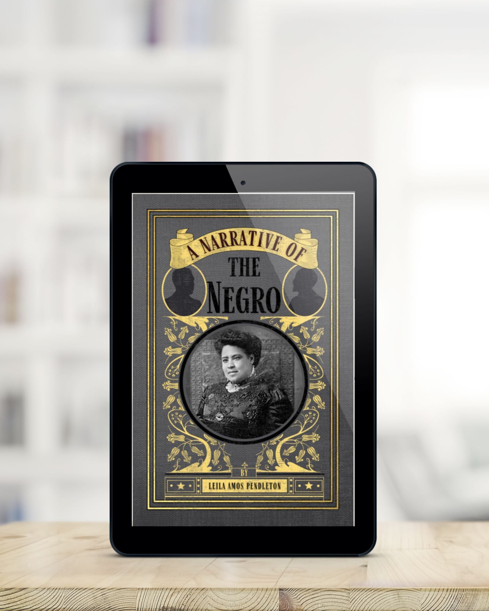 Glossy tablet showing the ebook cover of the grey and yellow A Narrative of the Negro. It is standing on a blonde wood table with the background blurred. 