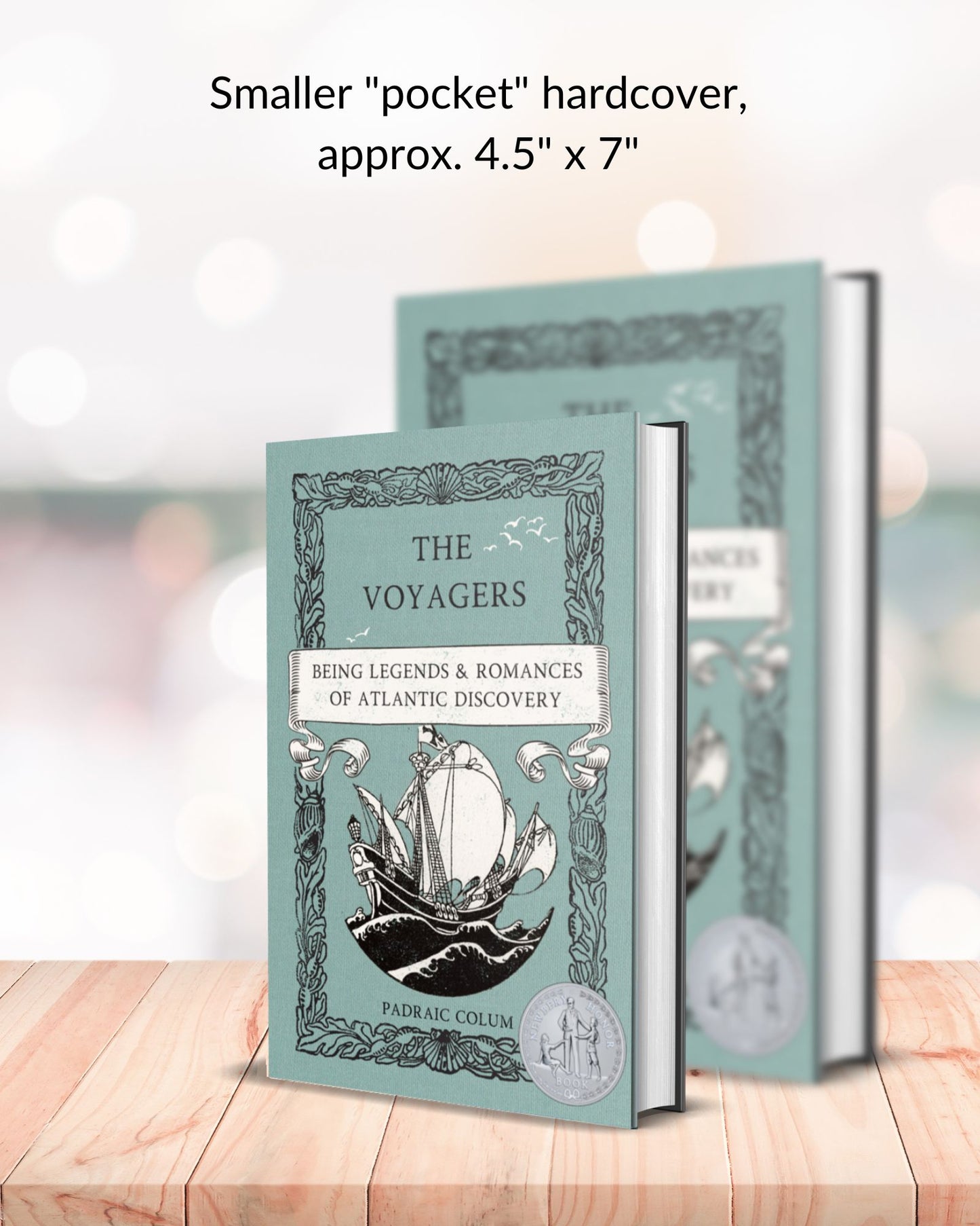2 copies of hardbacks with the teal cover of "The Voyagers: Being Legends & Romances of Atlantic Discovery" to show the size differentiation of the smaller, pocket hardcover. The smaller pocket size is in front of the larger, both standing on blonde shelf in front of a blurred background.